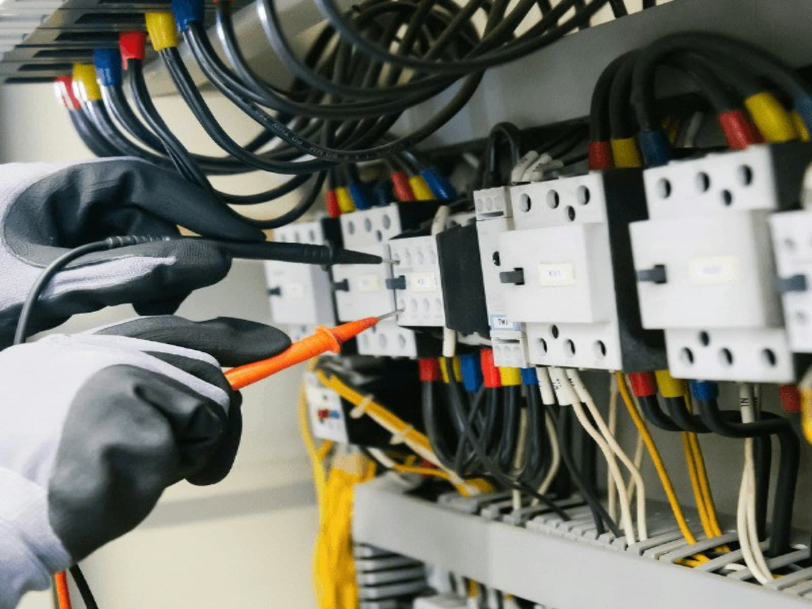 Electrician testing an electrical panel with a multimeter — Phila Electrical, KuGompo City